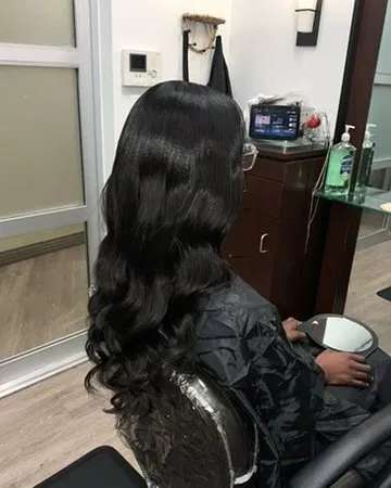 Sew-in install styled in soft Hollywood waves.